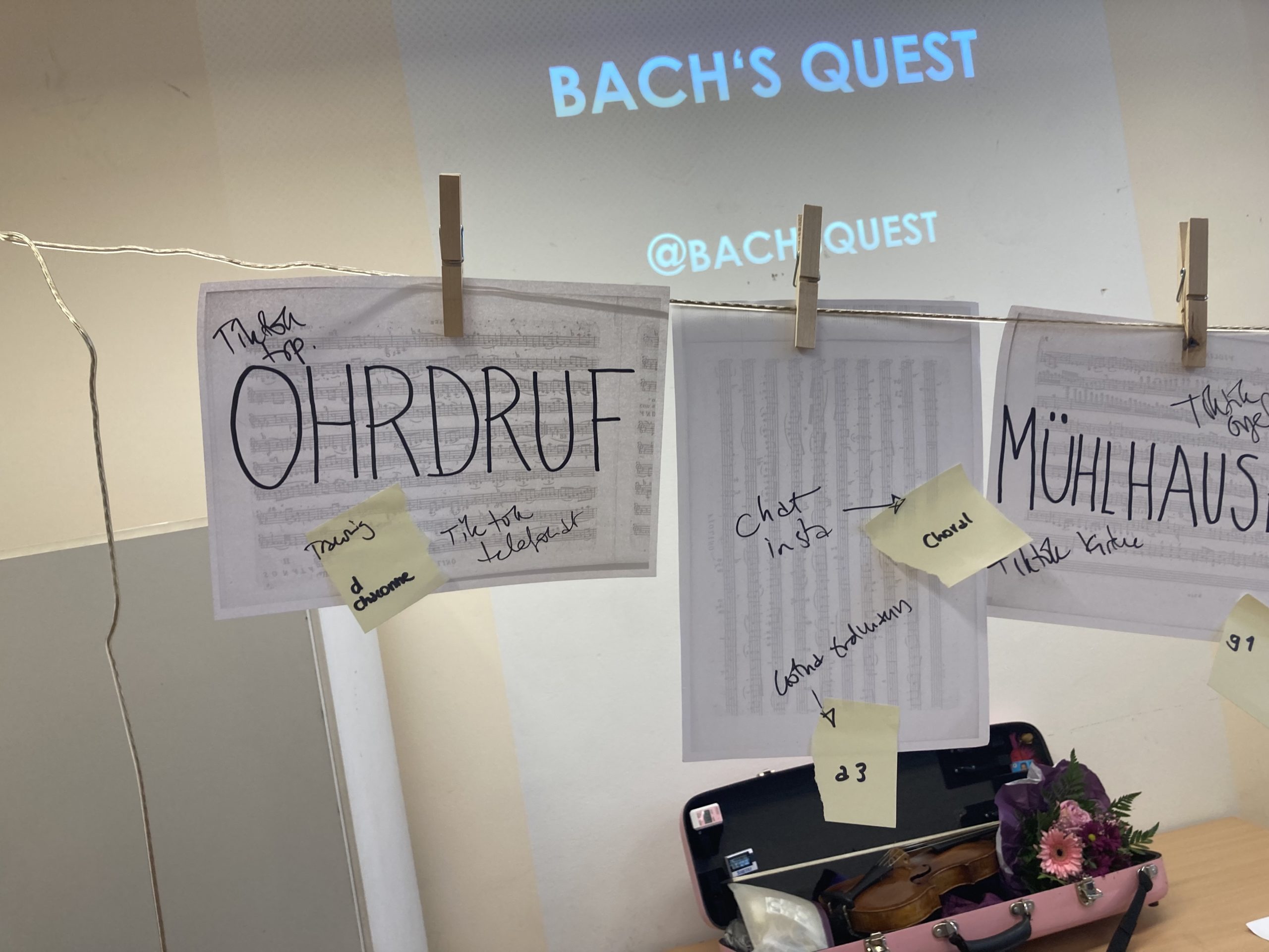 washing line with A4 pages with town names of Bach's journey hanging from it